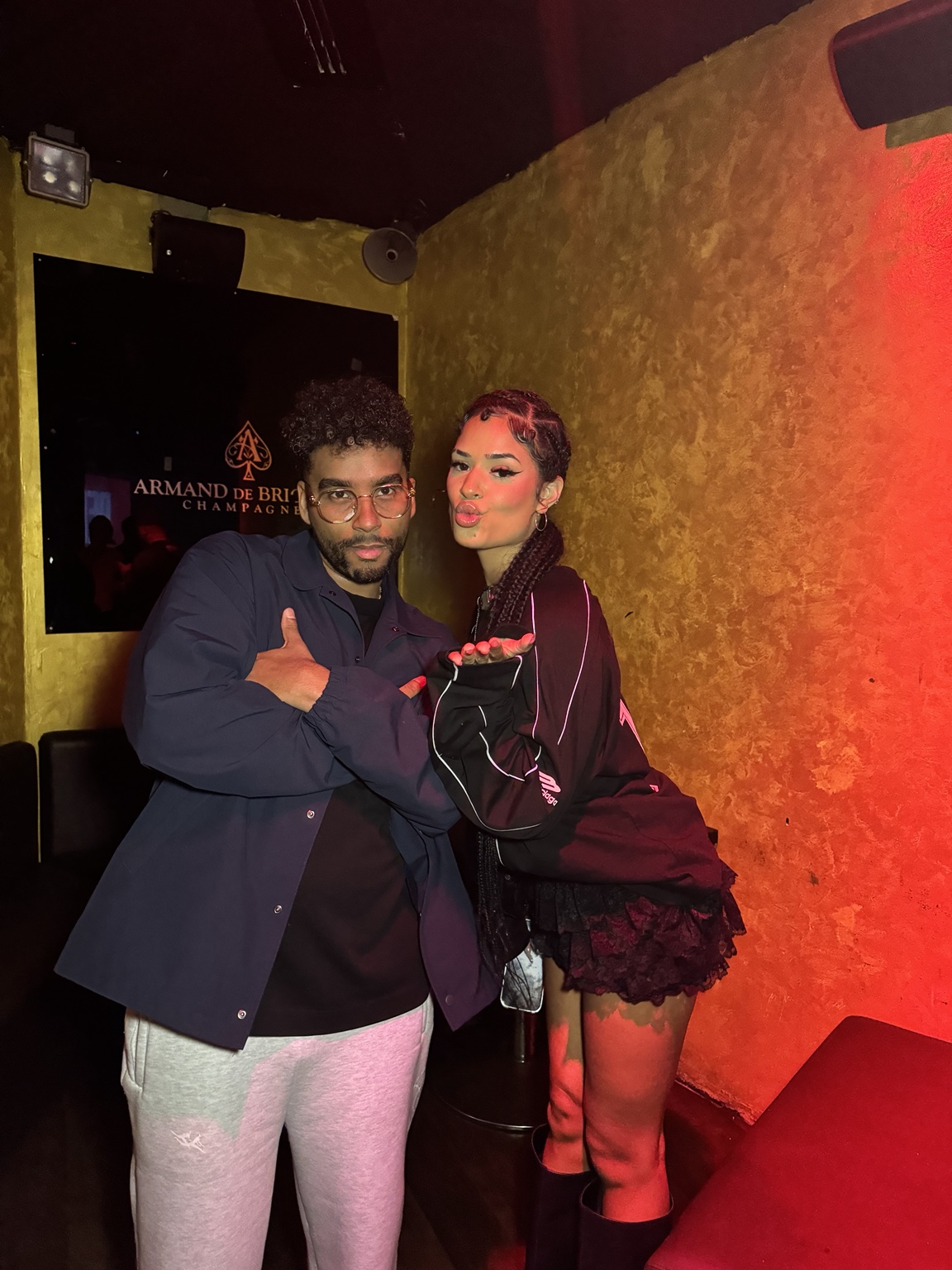 APXO backstage in a blue jacket beside DJ Nems
