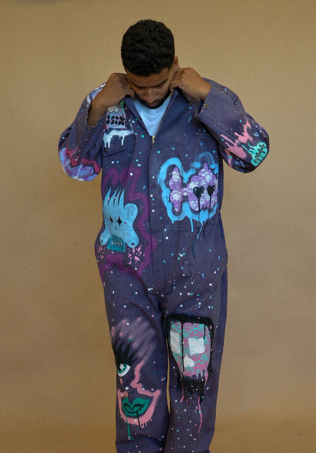 APXO wearing the one-of-one purple jumpsuit hand-painted by Mack of XCYR