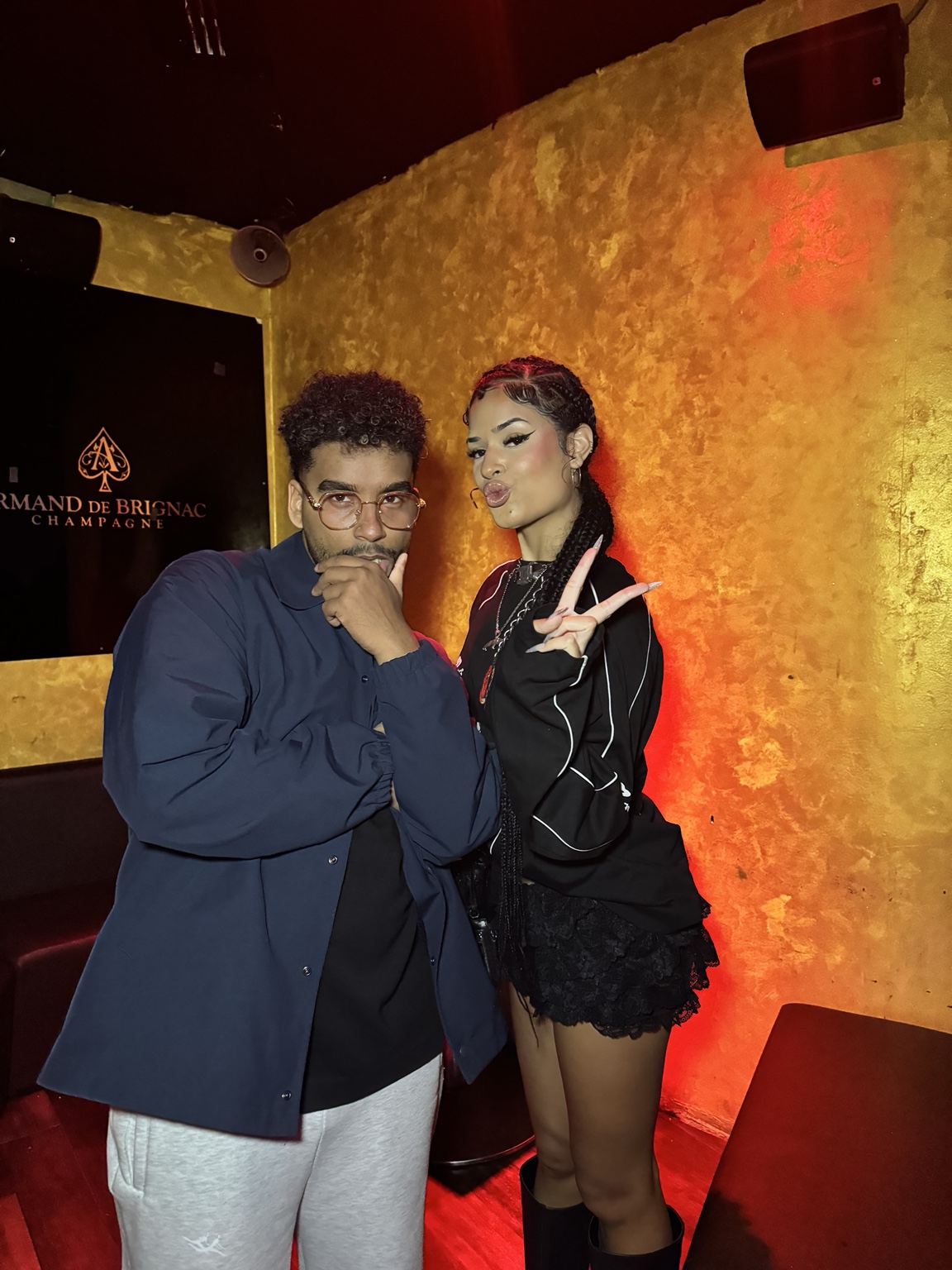 APXO and DJ Nems backstage, APXO with a hand to his chin